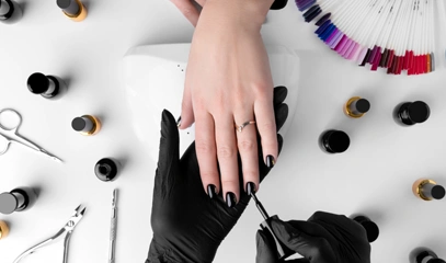 Woman making manicure beauty salon professional tools nail polish white table